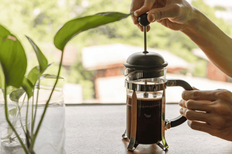 A man using French press coffee