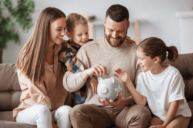 a happy couple sitting on the couch and learning how to save money with a family