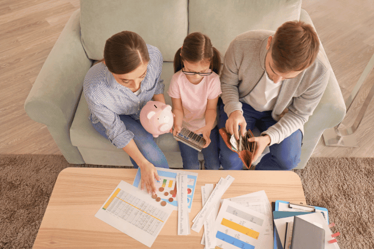Top view of a family counting money and set a monthly budget