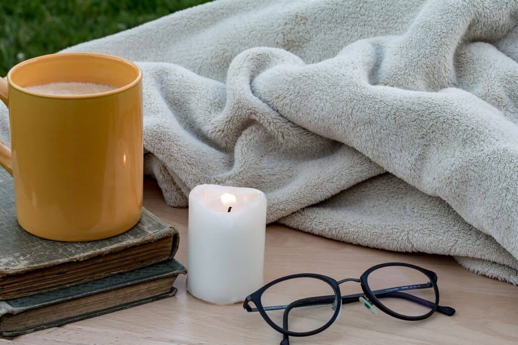 coffee and a candle and a blanket