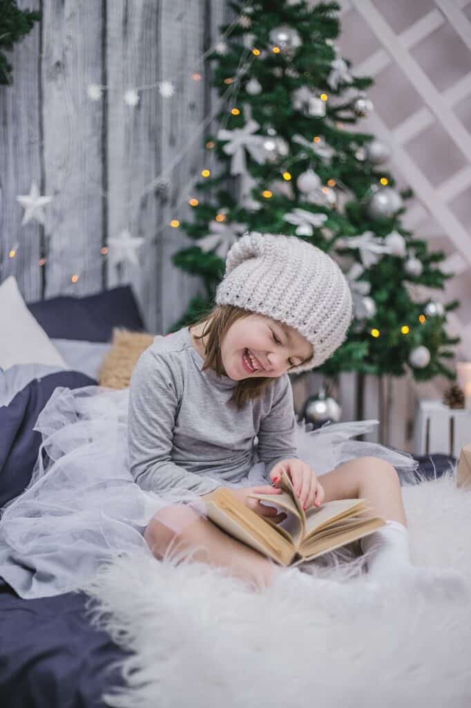 girl reading a Christmas book