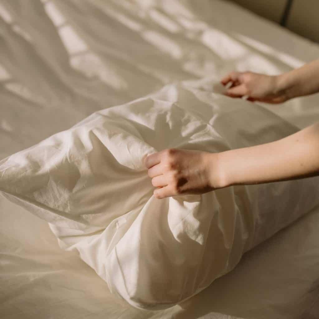fluffing up a pillow