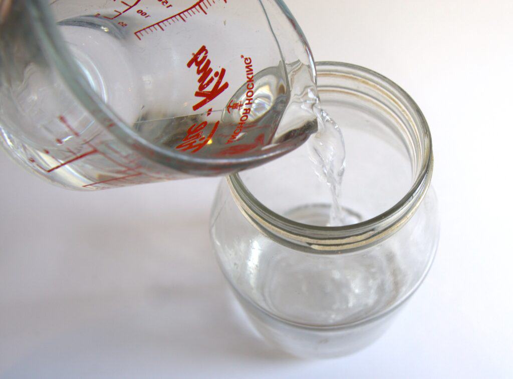 Pouring vinegar into a jar