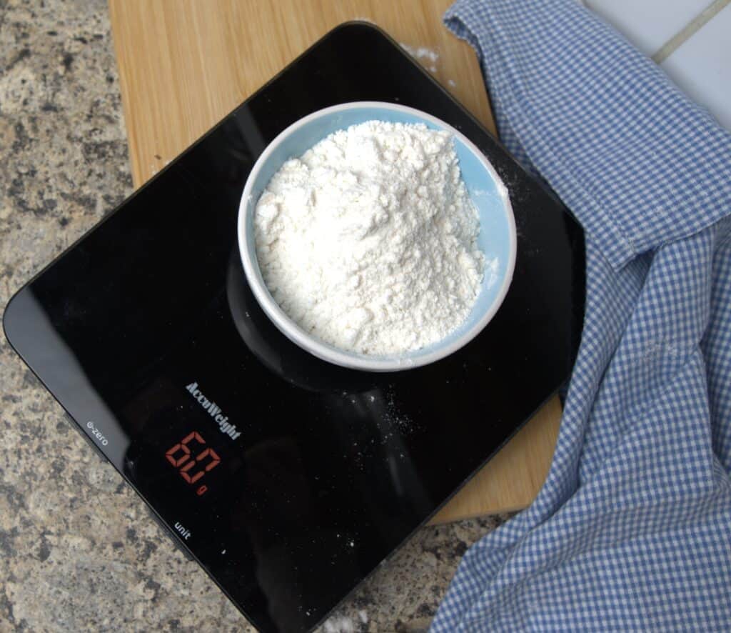 weighing flour on kitchen scale