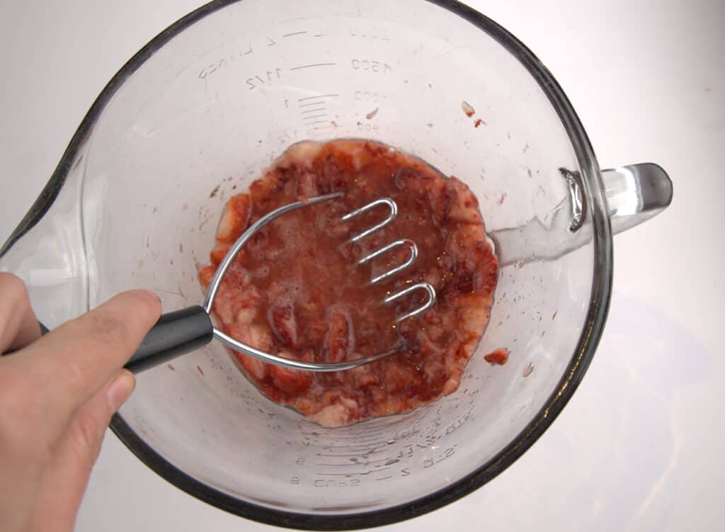 mashing strawberries